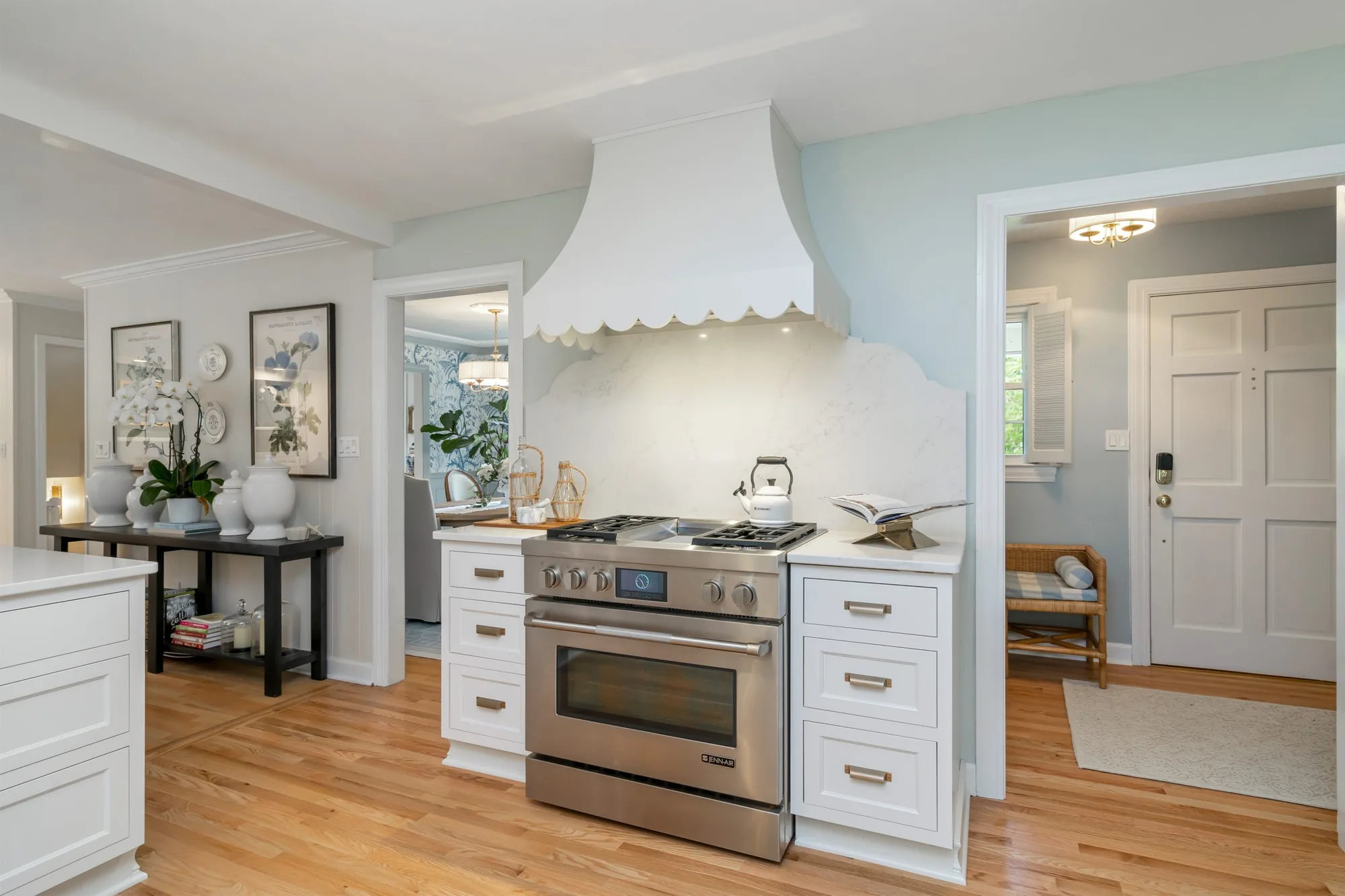 White kitchen with scalloped range hood